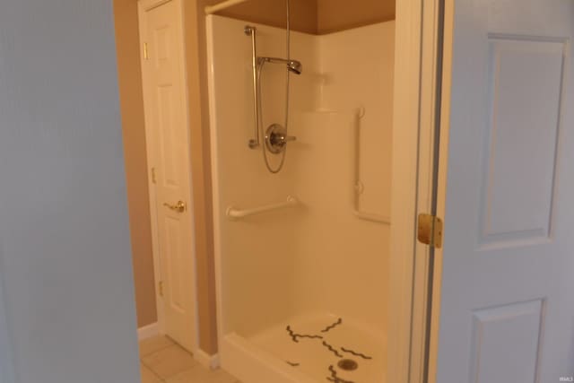 bathroom with tile patterned flooring and a shower