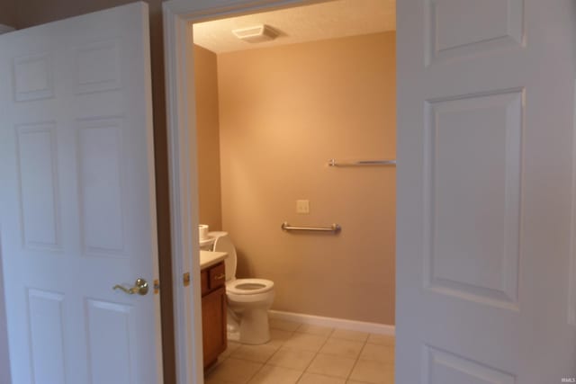 bathroom with tile patterned floors, vanity, and toilet