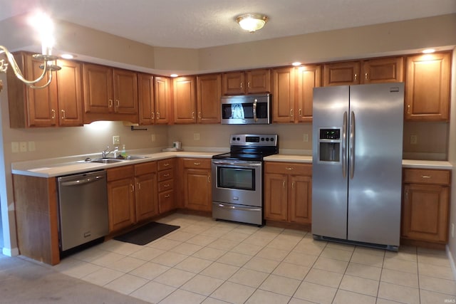 kitchen with sink, light tile patterned floors, and stainless steel appliances