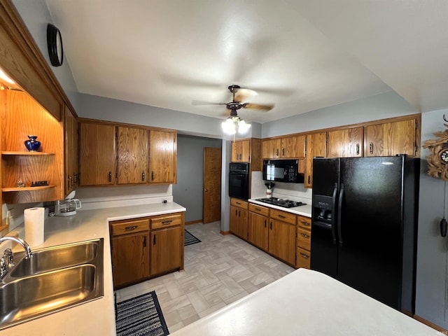 kitchen with black appliances, sink, and ceiling fan