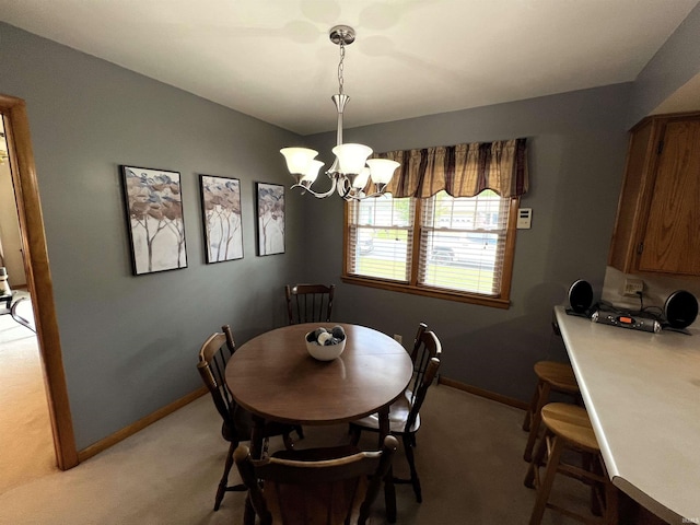 dining space featuring light colored carpet and an inviting chandelier