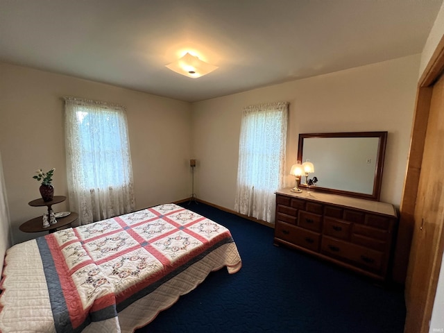 carpeted bedroom featuring multiple windows