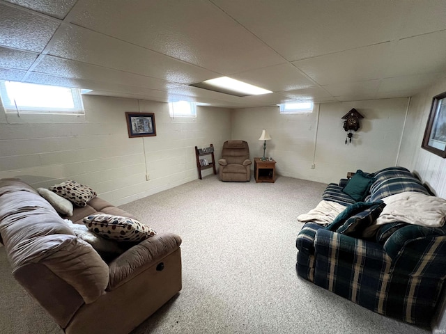 carpeted living room featuring a paneled ceiling and a wealth of natural light