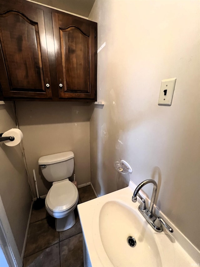 bathroom featuring vanity, tile patterned floors, and toilet