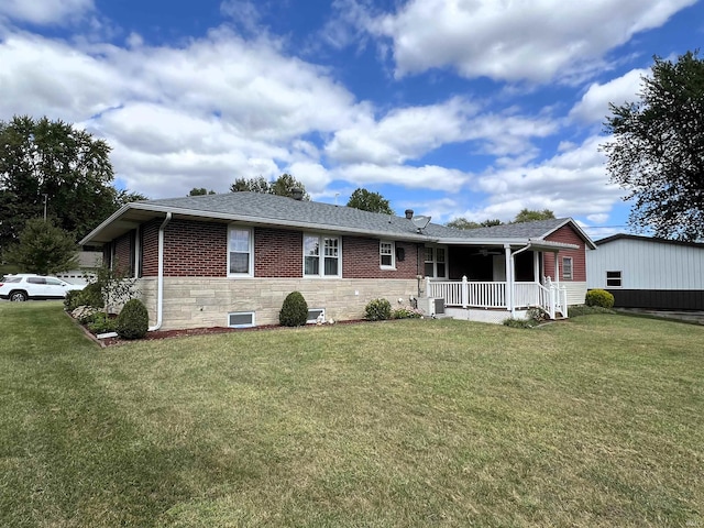 view of front of home featuring a front yard, central AC, and a porch