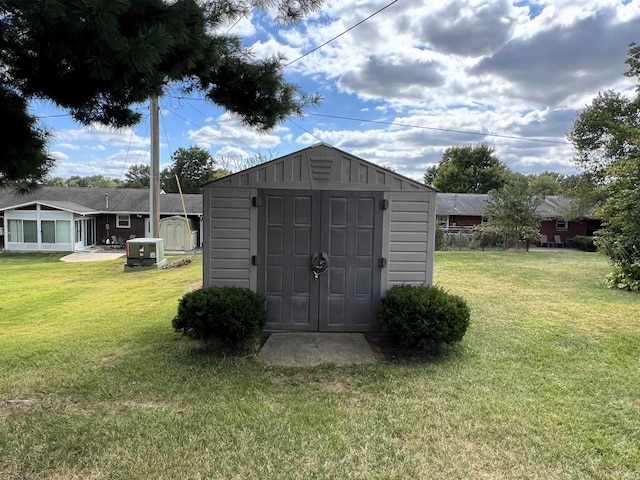 view of outbuilding with a yard