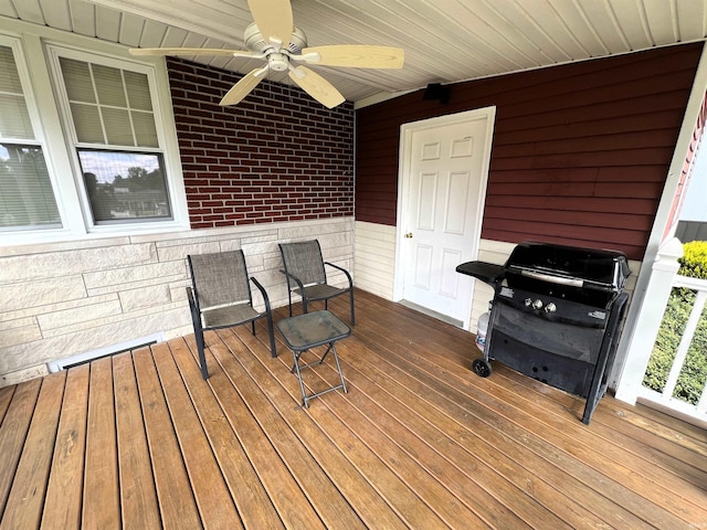 wooden terrace with area for grilling and ceiling fan