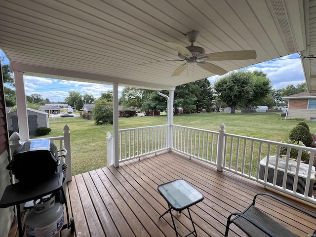 deck featuring a lawn and ceiling fan