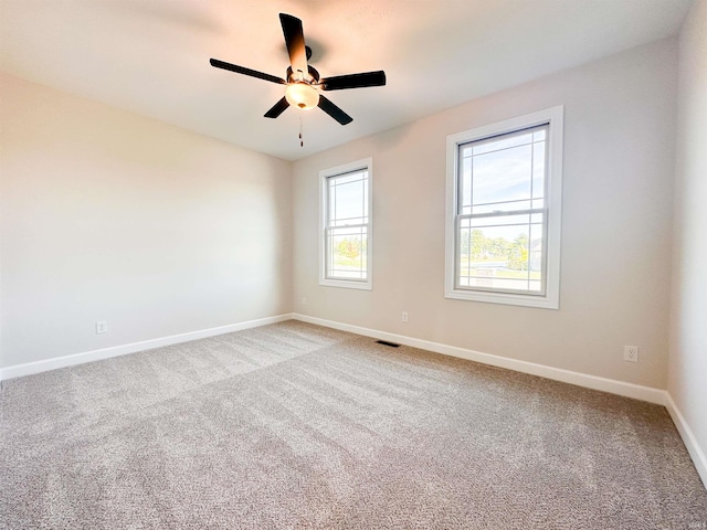 spare room featuring carpet and ceiling fan