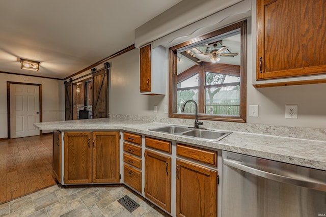 kitchen featuring vaulted ceiling, dishwasher, light hardwood / wood-style flooring, ceiling fan, and sink