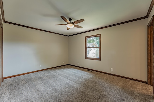 spare room featuring ornamental molding, ceiling fan, and carpet flooring