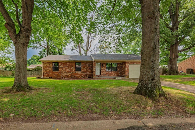 single story home with a garage and a front lawn