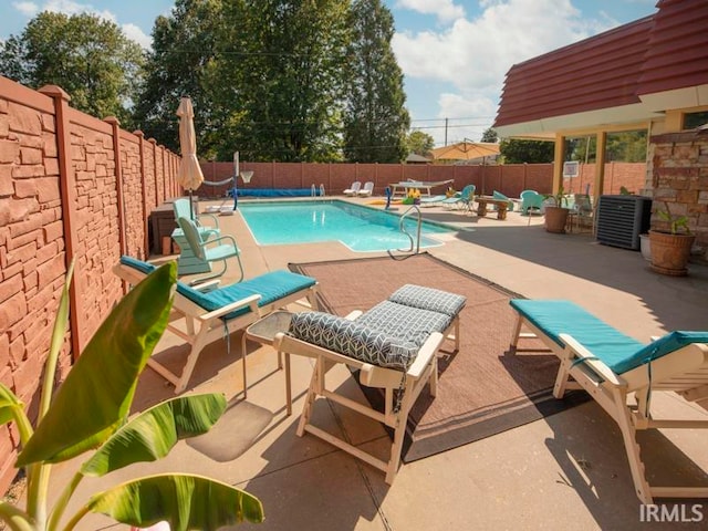 view of pool with a patio and central AC