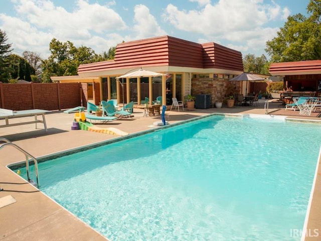 view of swimming pool with a patio area