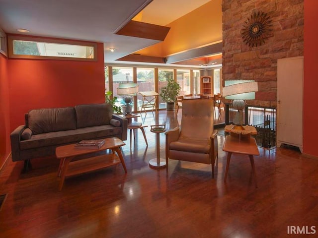 living room featuring vaulted ceiling and hardwood / wood-style floors