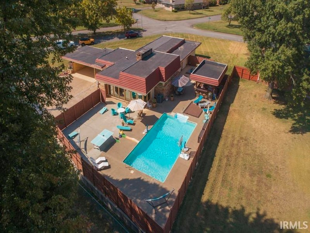 view of pool with a storage shed and a patio area