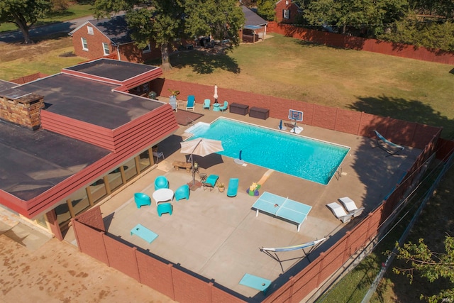 view of swimming pool featuring a lawn and a patio area