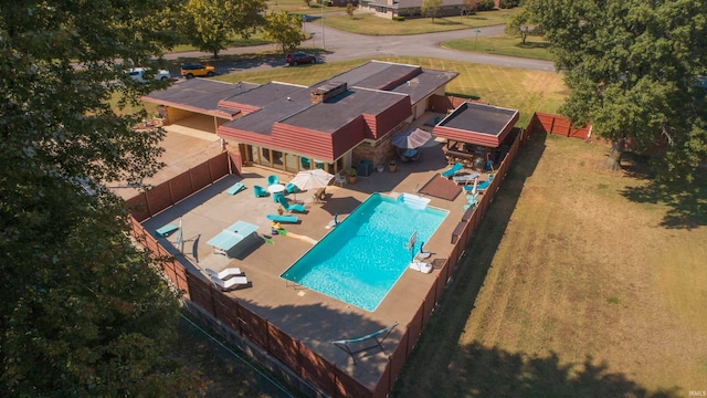 view of pool featuring a shed and a patio area