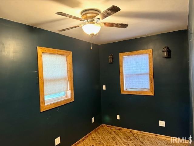 unfurnished room featuring ceiling fan and hardwood / wood-style floors