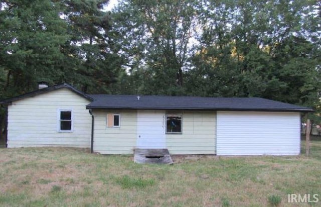 rear view of house with a lawn