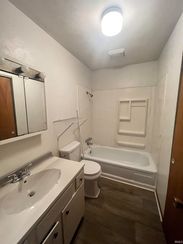 full bathroom with hardwood / wood-style flooring, shower / bath combination, vanity, and toilet