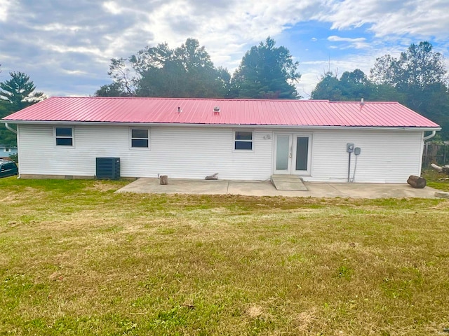 rear view of property with a patio, a lawn, central AC unit, and french doors