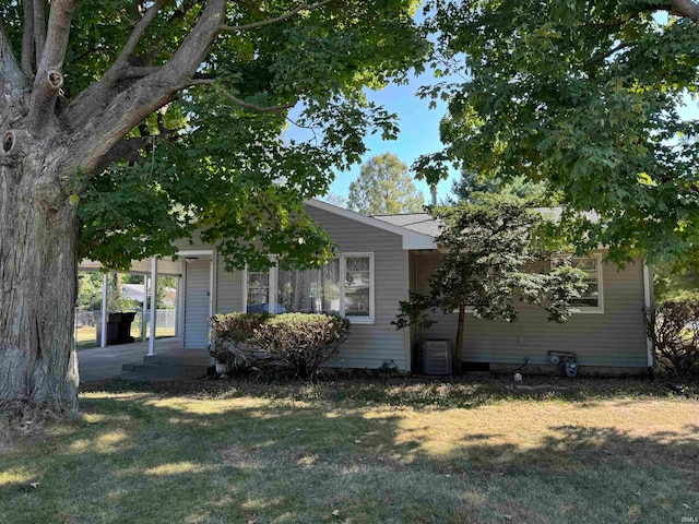 view of front facade with central AC and a front yard