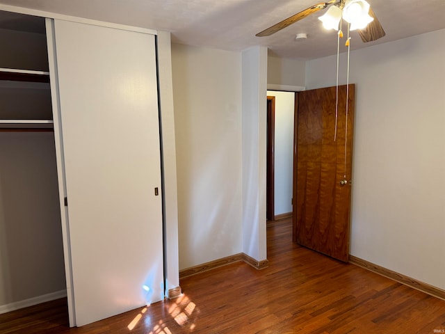 unfurnished bedroom featuring dark hardwood / wood-style floors and ceiling fan