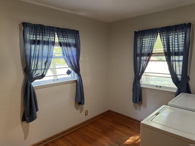 laundry room featuring washer and clothes dryer and hardwood / wood-style flooring