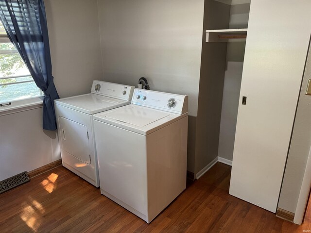 washroom with dark wood-type flooring and washing machine and clothes dryer