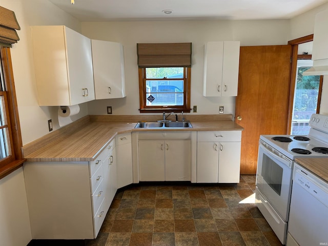 kitchen featuring white appliances, white cabinetry, and sink