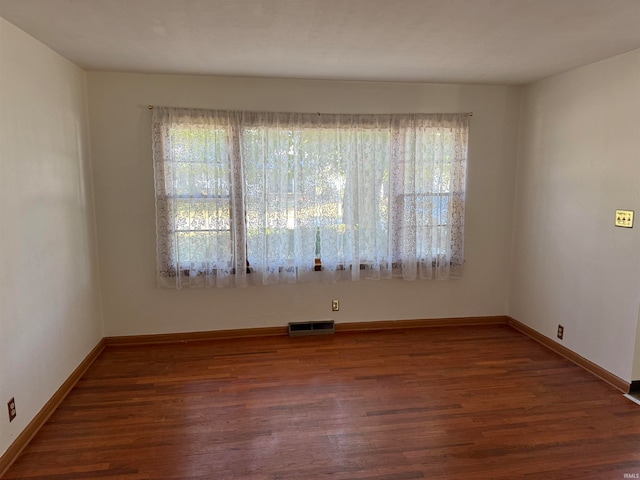 spare room featuring dark hardwood / wood-style floors