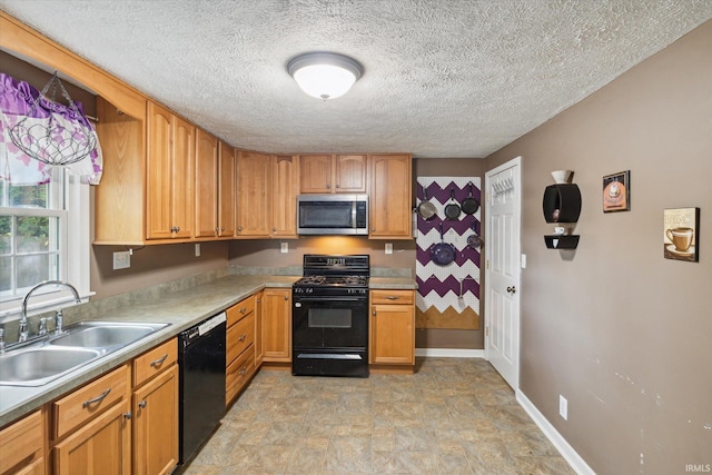 kitchen featuring black appliances, a textured ceiling, and sink