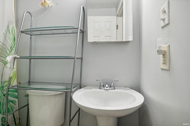 bathroom with a textured ceiling and sink