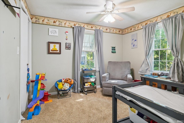 carpeted bedroom with multiple windows and ceiling fan