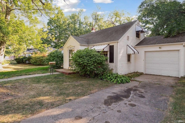 view of side of home featuring a yard and a garage