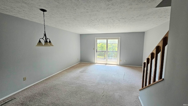 spare room featuring a textured ceiling and carpet flooring