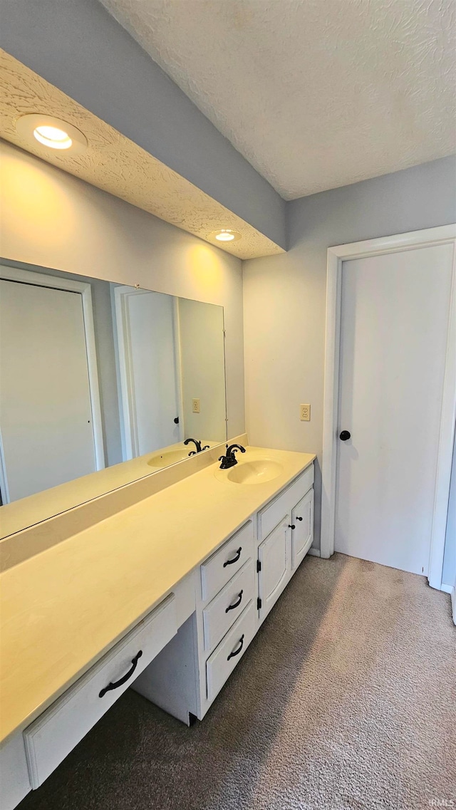 bathroom featuring a textured ceiling and vanity