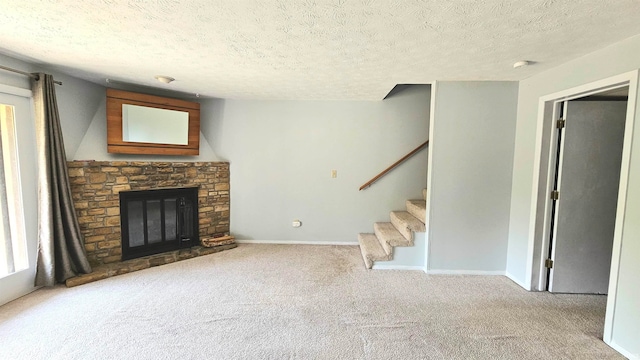 unfurnished living room featuring light carpet and a textured ceiling