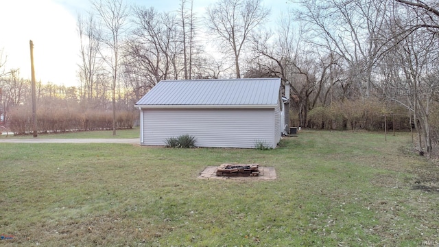 yard at dusk featuring an outdoor fire pit