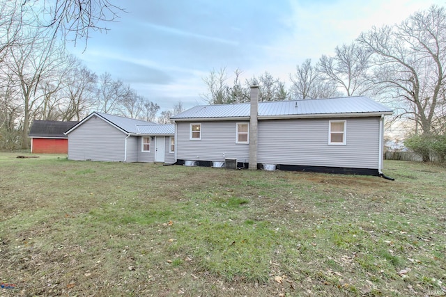 rear view of house featuring a lawn