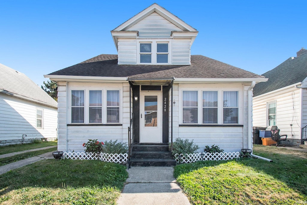 bungalow-style house featuring a front yard