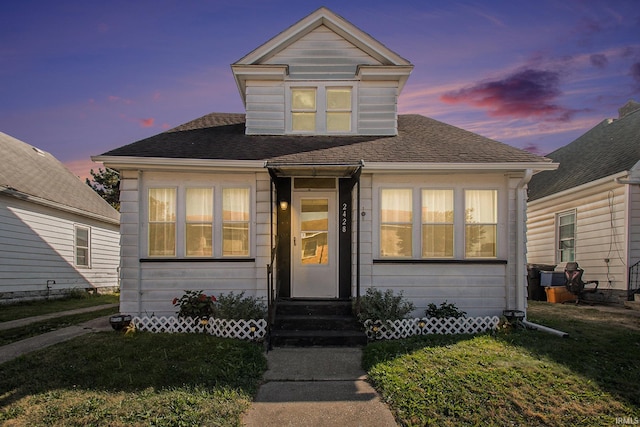 bungalow-style house featuring a yard