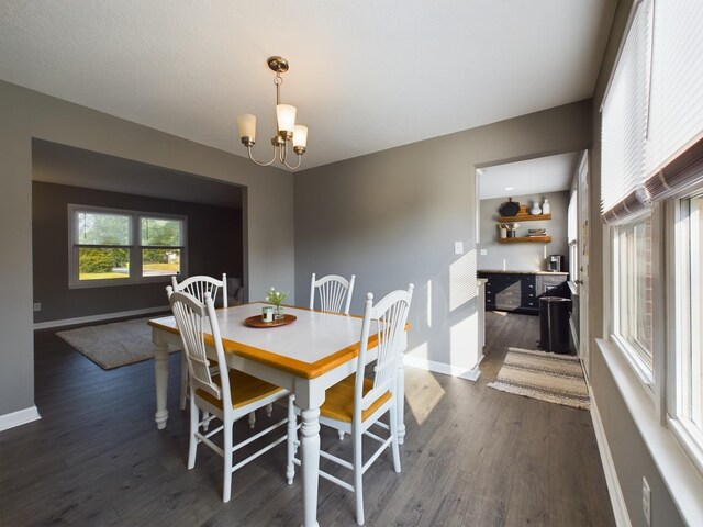 dining room featuring dark hardwood / wood-style floors and a notable chandelier