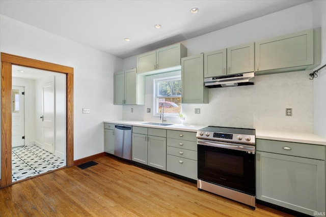 kitchen featuring light hardwood / wood-style flooring, stainless steel appliances, and sink