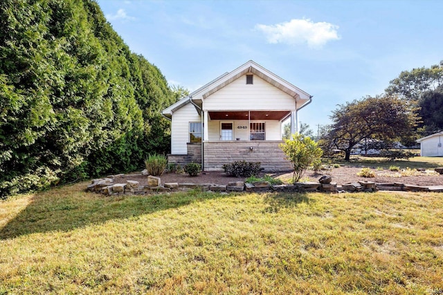 view of home's exterior with a lawn and covered porch