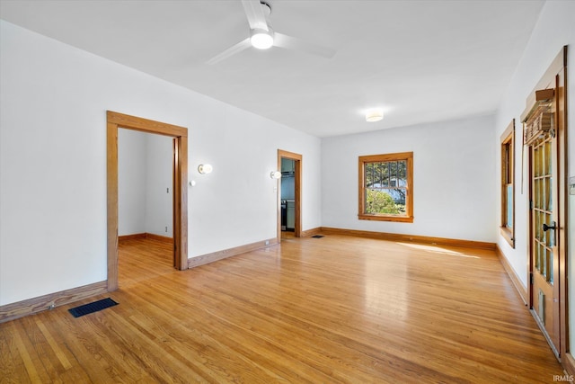 spare room featuring ceiling fan and light wood-type flooring