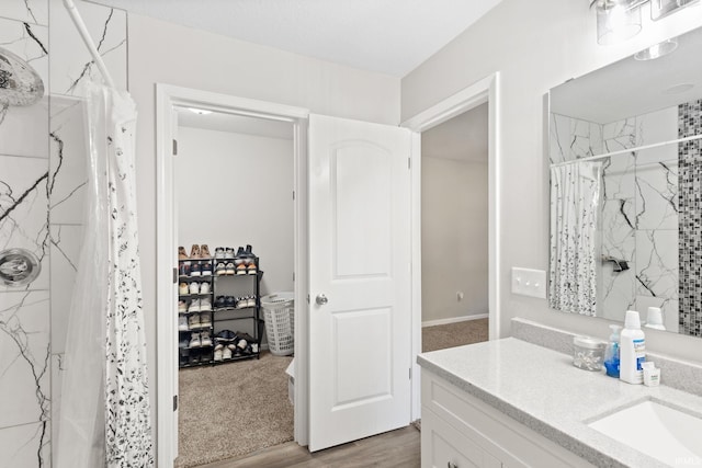 bathroom with vanity, a shower with curtain, and hardwood / wood-style floors