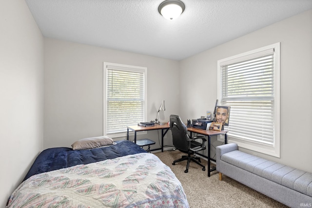 carpeted bedroom featuring a textured ceiling