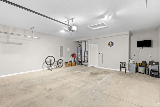 garage with a garage door opener, gas water heater, and electric panel